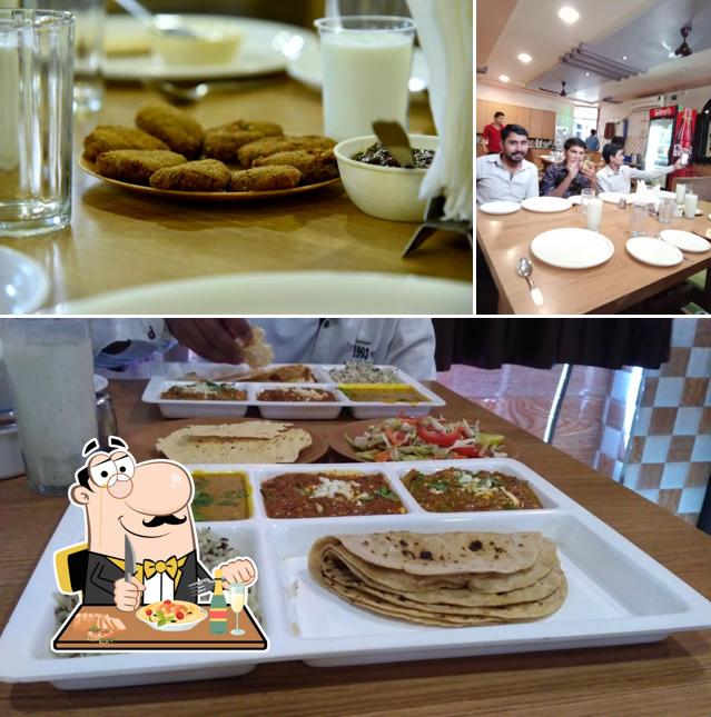 Check out the image depicting food and dining table at Chamunda Restaurant & Dinning Hall