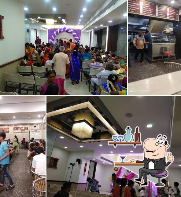 Take a seat at one of the tables at Hotel Parijatha and Party Hall