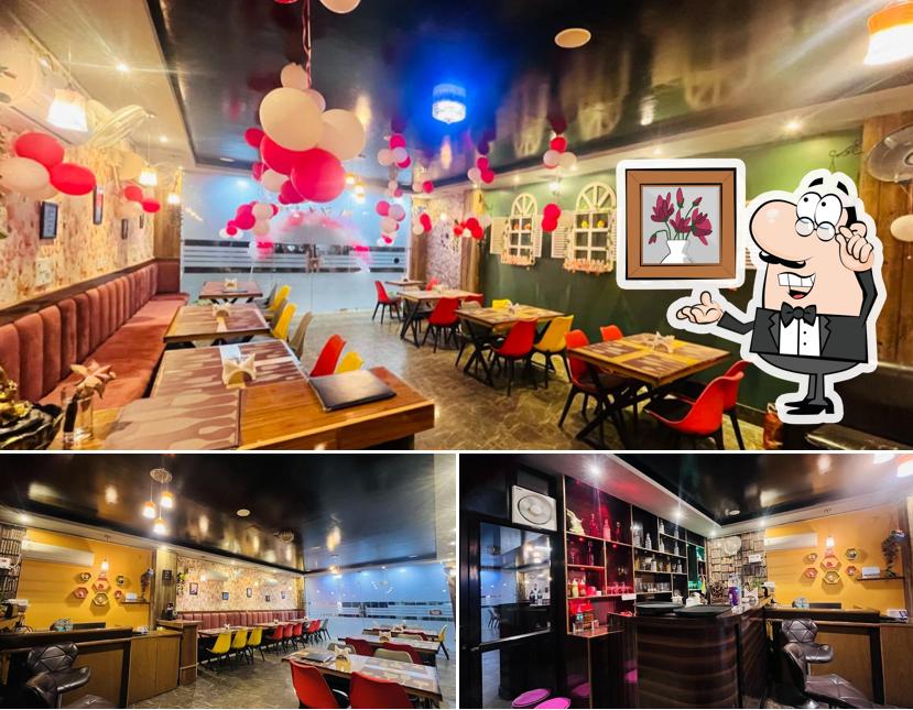 Take a seat at one of the tables at The 7 Ages Cafe And Restro