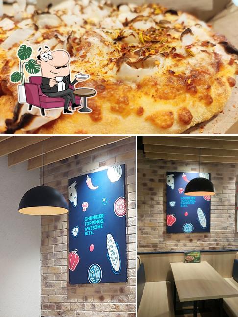The photo of interior and pizza at Domino's Pizza Bilekahalli, BANGALORE