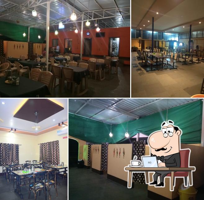 Take a seat at one of the tables at Hotel Anugraha restaurant chikkodi