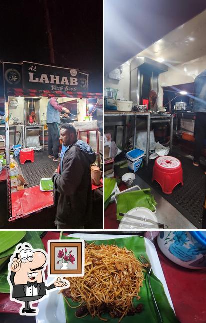 Take a look at the image depicting interior and food at Al Lahab Food Court