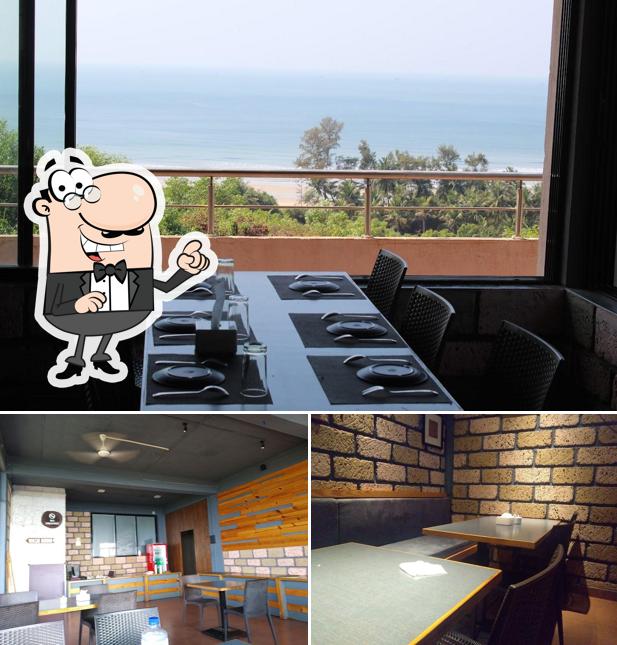 Take a seat at one of the tables at O'NEST Nakshatra Restaurant And Bar