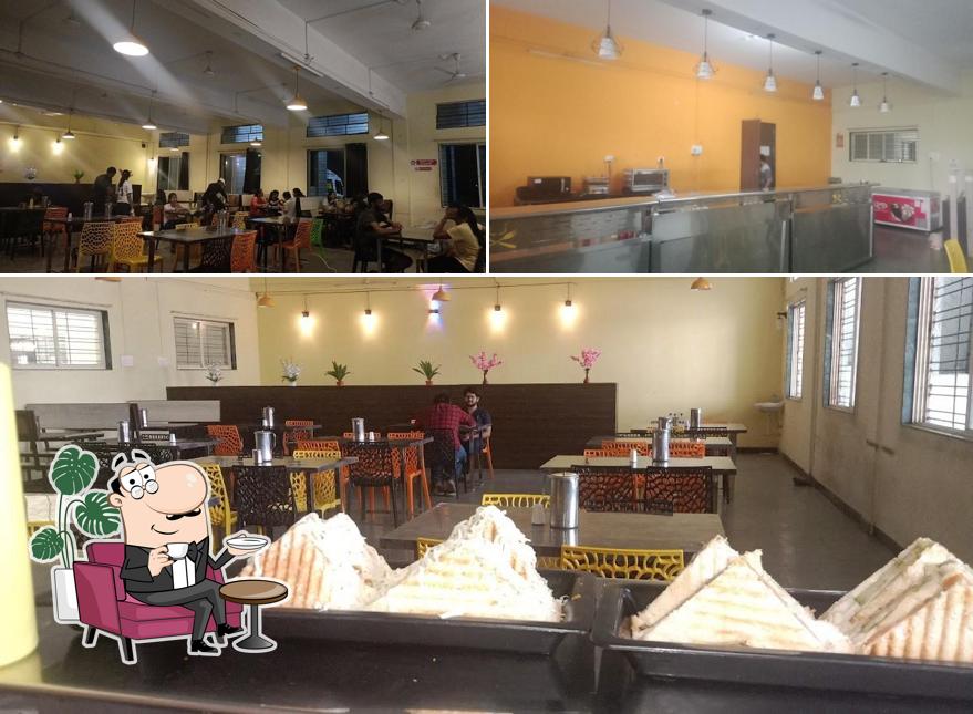 Take a seat at one of the tables at Ashwini Cafeteria