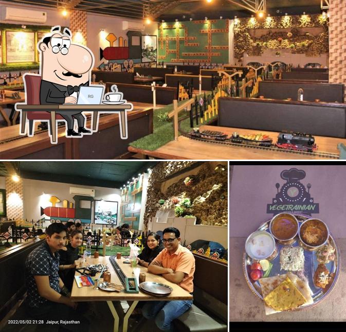 Take a seat at one of the tables at Vegetrainian - The Train Restaurant