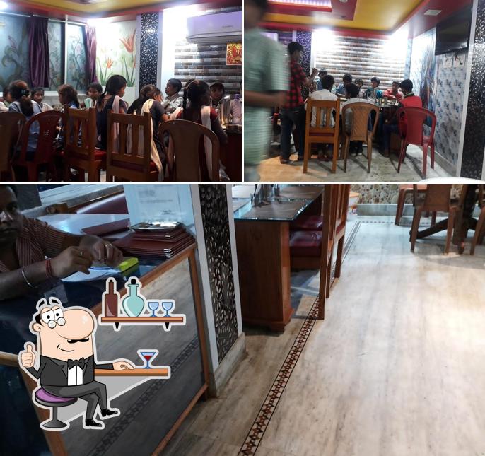 Take a seat at one of the tables at Gupta ac family restaurant