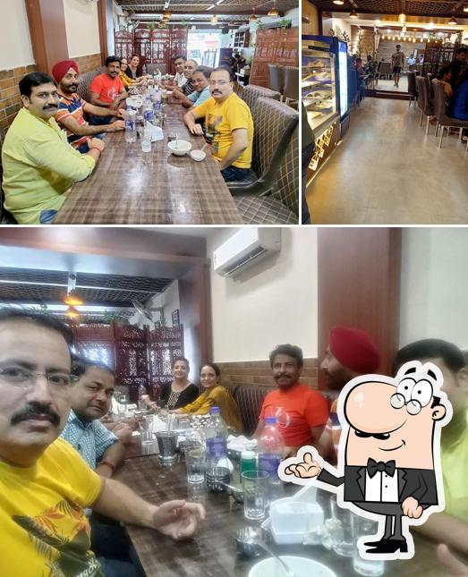 Take a seat at one of the tables at Kesar Dine - A Multi-cuisine Restaurant
