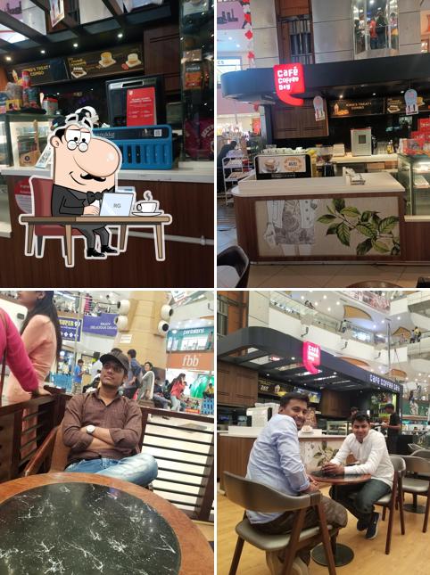 Take a seat at one of the tables at Cafe Coffee Day Take a seat at one of the tables at Cafe Coffee Day