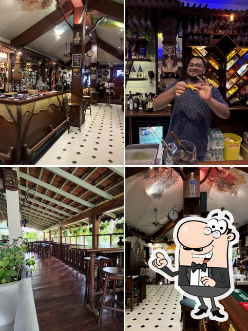 Take a seat at one of the tables at Carlito’s Attique - Goan Cafe & Bar