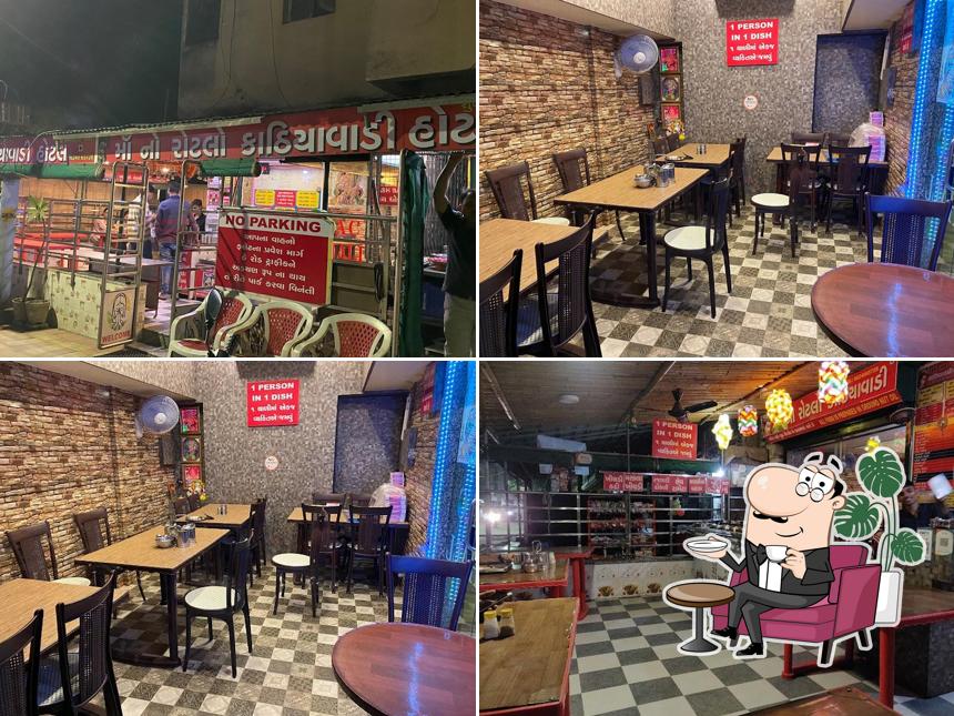 Take a seat at one of the tables at Maa No Rotlo-Kathiyawadi Hotel