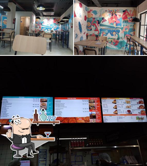 Take a seat at one of the tables at Domino's Pizza