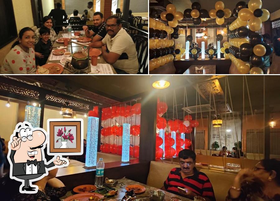 Take a seat at one of the tables at ISIRI Multi Cuisine Restaurant