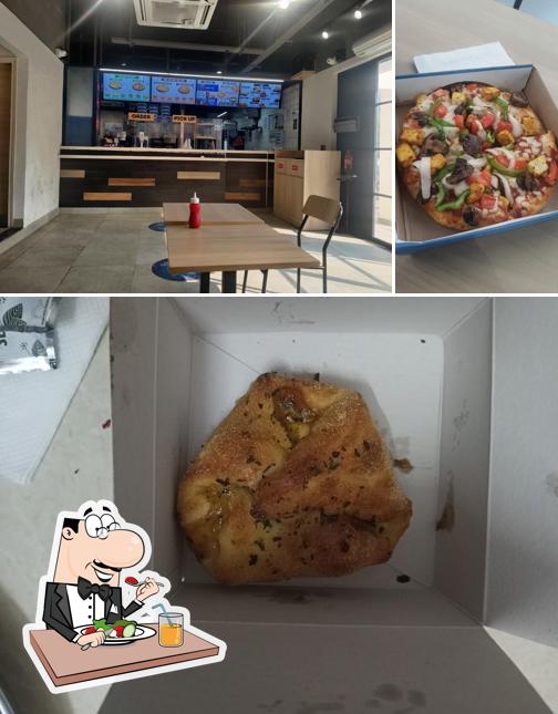 Among various things one can find food and interior at Domino's Pizza Paras Chouraha, Hiran Magri