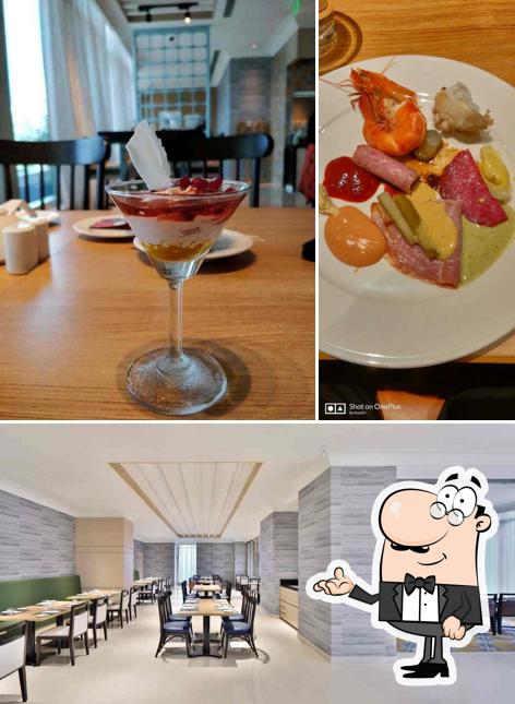 Take a seat at one of the tables at The Eatery - Four Points by Sheraton