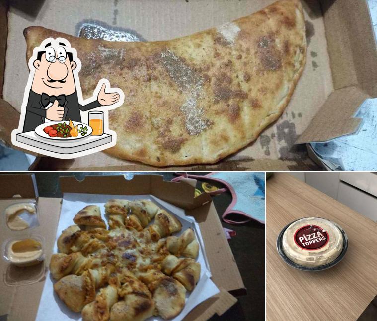 The photo of food and interior at Pizza Toppers - Monster Cheese Burst Pizza