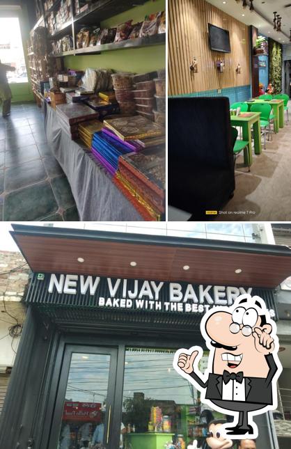 Take a seat at one of the tables at New Vijay Bakery - Cake Shop/Amritsari Kulcha/Snacks Restaurant/Best Baker Shop in Batala