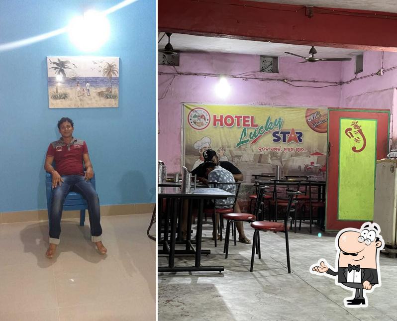 Take a seat at one of the tables at HOTEL LUCKY STAR