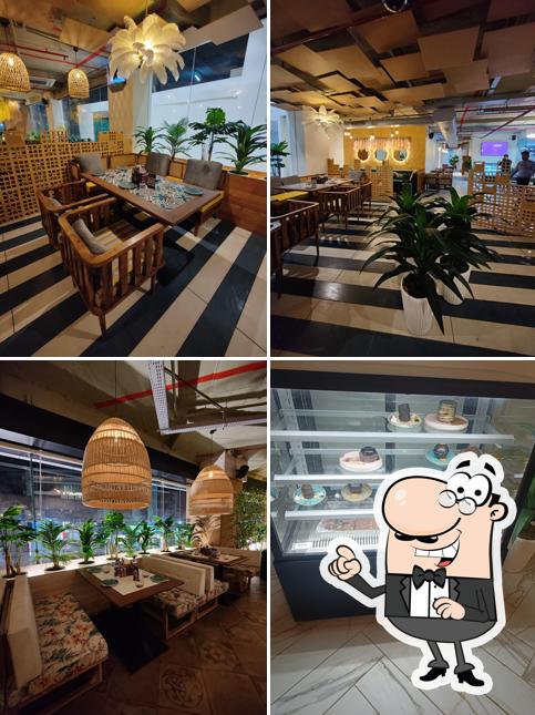 Take a seat at one of the tables at Thyme & Whisk - Best Restaurant In Jubilee Hills Pure Veg Restaurant Multi Cuisine Restaurant