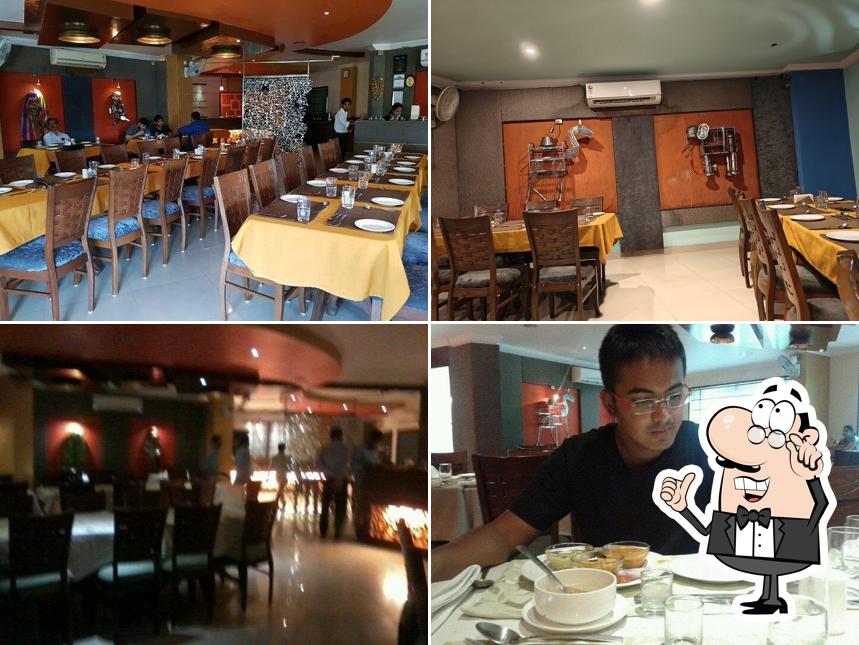 Take a seat at one of the tables at Udaipuri Restaurant