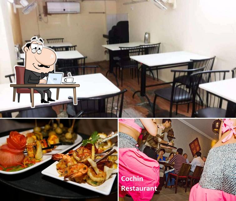 Take a seat at one of the tables at Cochin Ark Restaurant