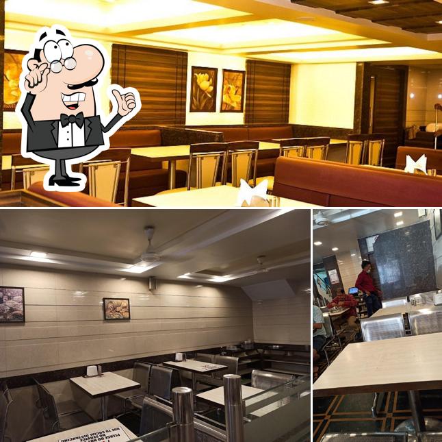 Take a seat at one of the tables at Navtara Veg Restaurant