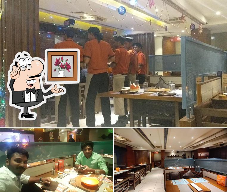 Take a seat at one of the tables at Barbeque Nation - Madurai - Milan'em Mall