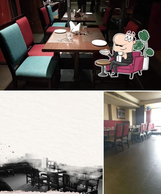 Take a seat at one of the tables at Surya Mahal Restaurant
