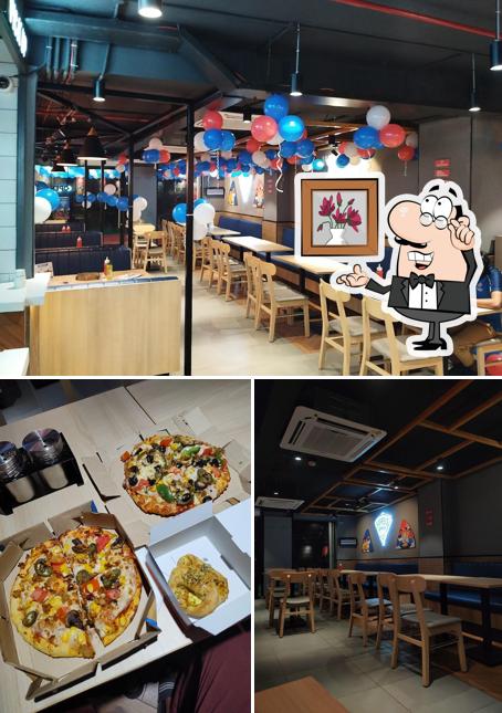 The picture of interior and food at Domino's Pizza Tadepalle, Guntur