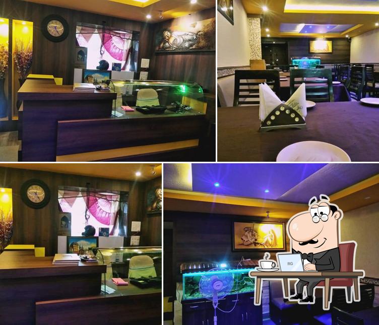 Take a seat at one of the tables at Vyanjan Restaurant