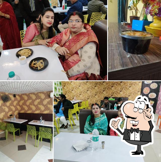 Take a seat at one of the tables at Shree Radhey Restaurant