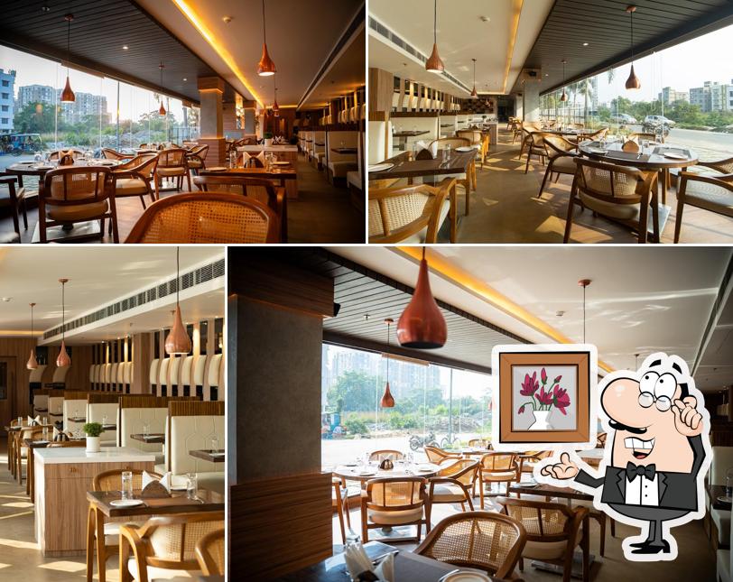 Take a seat at one of the tables at Calcutta Bistro - Chinar Park