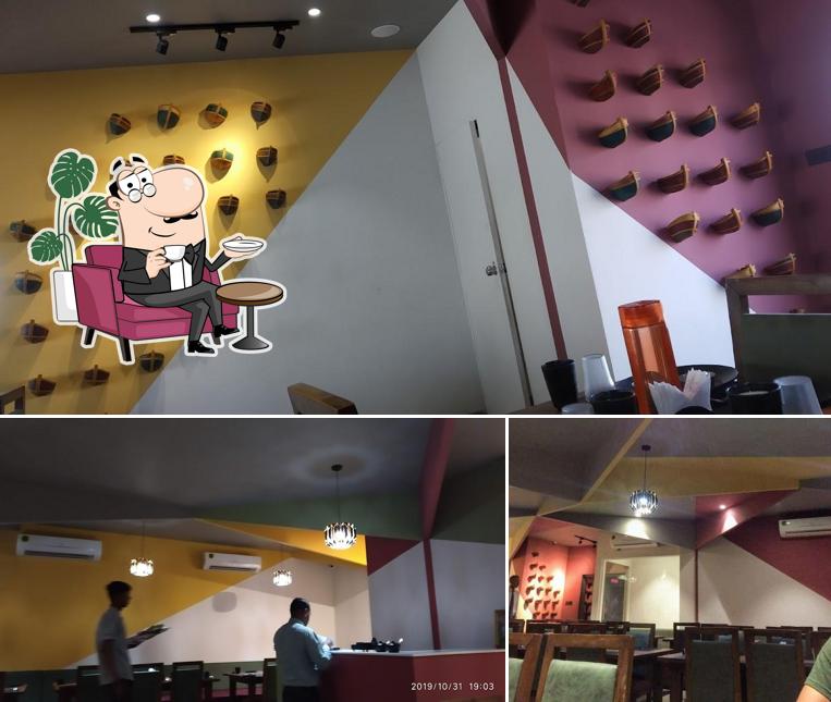 Take a seat at one of the tables at Keshav Restaurant