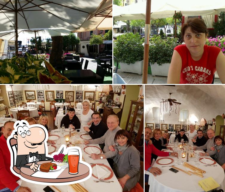 La foto di tavolo da pranzo e esterno da Ristorante Da Vittorio
