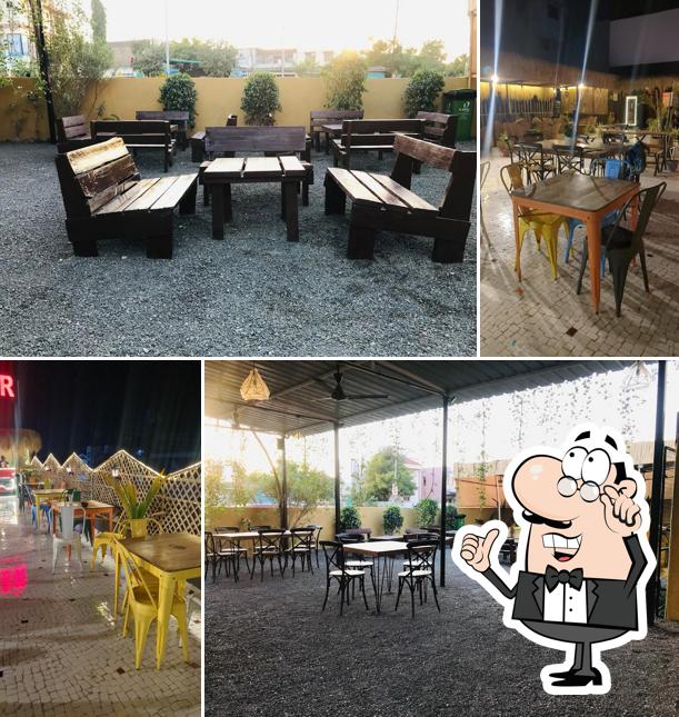 Take a seat at one of the tables at Jam Sham Rooftop Cafe
