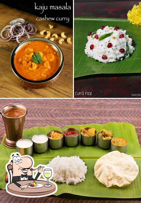 The picture of Deluxe Pure Vegetarian Restaurant Amalapuram’s food and dining table