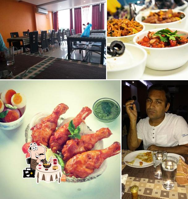 Among different things one can find food and dining table at HOTEL VAISHNAVI HEIGHTS