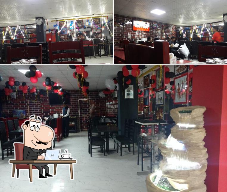 Take a seat at one of the tables at YOO YOO TOWN RESTRO AND PARTY HALL