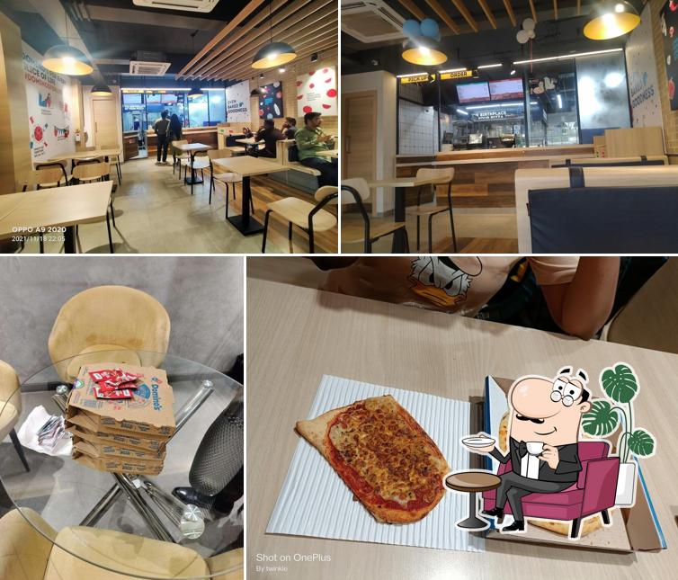 Take a seat at one of the tables at Domino's Pizza Vishnu Nagar, Palghar