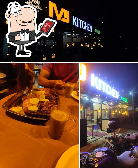 This is the photo displaying exterior and dining table at MJ Kitchen & Restuarent Payyannur