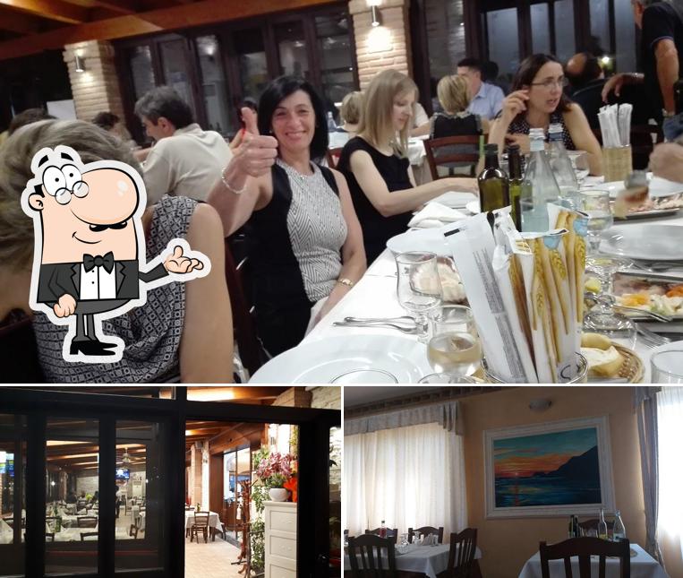 Questa è la foto che mostra la interni e tavolo da pranzo di Ristorante Hotel La Perla