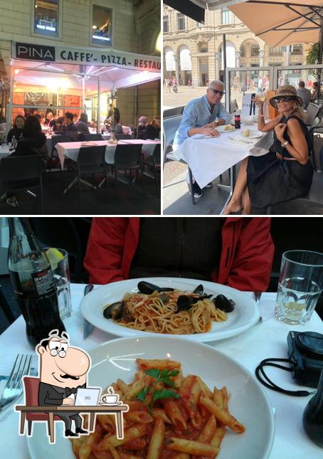 La foto di interni e tavolo da pranzo da Pina Restaurant Cafè