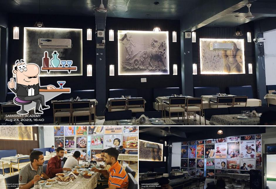Take a seat at one of the tables at Snacks Adda Restaurant