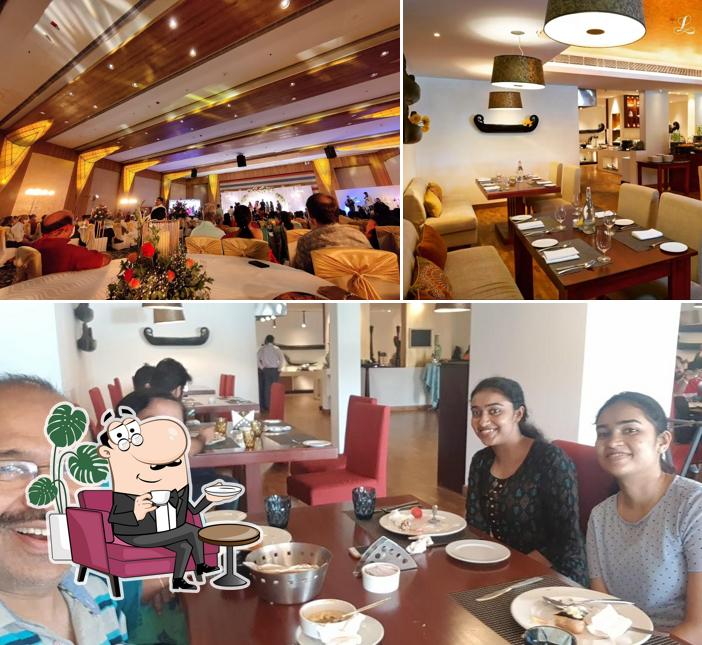 Take a seat at one of the tables at Keraleeyam Restaurant at The Leela Ashtamudi- A Raviz Hotel