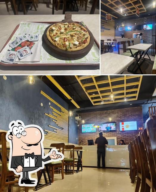 This is the image showing interior and food at Canadian Pizza & Burger Malout