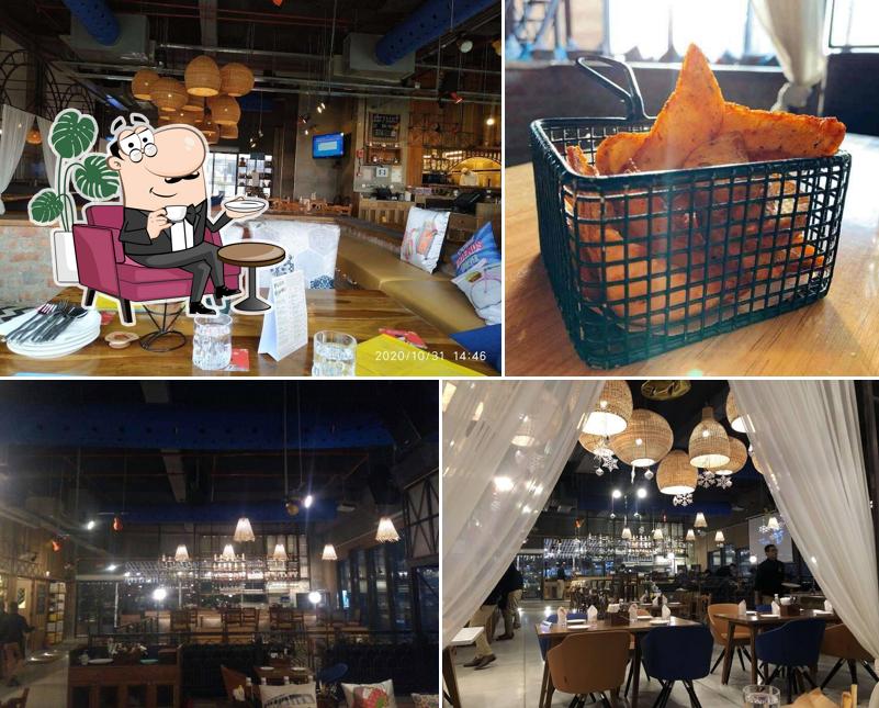 Take a seat at one of the tables at Cafe Delhi Heights