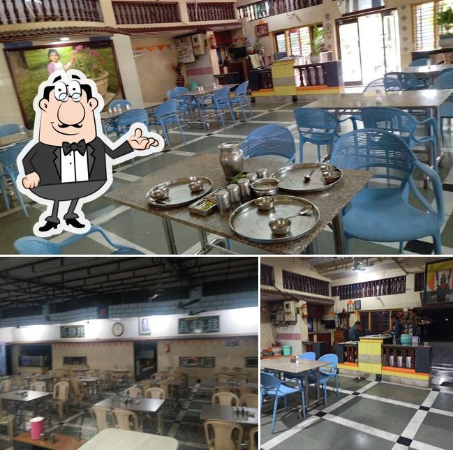 Take a seat at one of the tables at Nilkanth Bhojanam