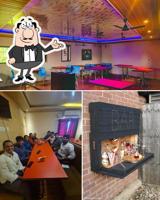 Take a seat at one of the tables at SUNIL BAR AND RESTAURANT