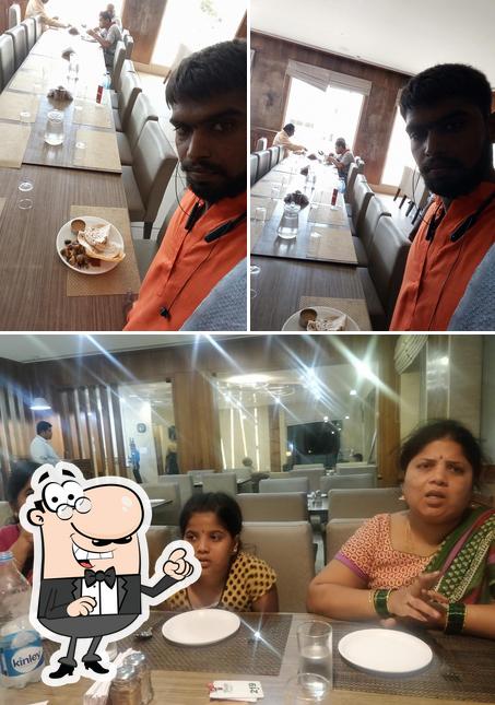 This is the picture displaying interior and dining table at Shabari Restaurant