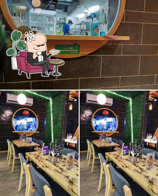 Take a seat at one of the tables at Cheelizza India Ka Pizza