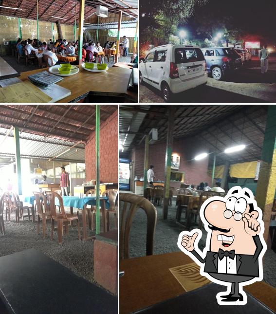 Take a seat at one of the tables at Hotel Nisarg